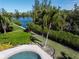 Private pool and canal view with lush landscaping at 3260 Bayou Rd, Longboat Key, FL 34228