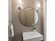 Modern powder room with a round mirror and neutral tones at 3260 Bayou Rd, Longboat Key, FL 34228