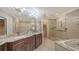 Spa-like bathroom with double vanity, large shower, and bathtub at 380 Gulf Of Mexico Dr # 525, Longboat Key, FL 34228