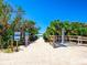 Beach access with shower and signage at 411 S Casey Key Rd, Nokomis, FL 34275