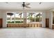 Sunroom with water damage being repaired, overlooking canal at 411 S Casey Key Rd, Nokomis, FL 34275