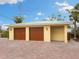 Two-car garage with attractive wooden doors at 411 S Casey Key Rd, Nokomis, FL 34275