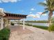 Pergola-covered patio overlooking the water at 411 S Casey Key Rd, Nokomis, FL 34275