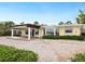 Covered patio with brick pavers and tranquil waterfront views at 411 S Casey Key Rd, Nokomis, FL 34275