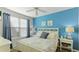 Main bedroom with a king-size bed and light blue accent wall at 4142 Central Sarasota Pkwy # 1428, Sarasota, FL 34238