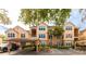 Front view of a two-story condo building with parking and landscaping at 4142 Central Sarasota Pkwy # 1428, Sarasota, FL 34238