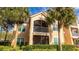 Well-maintained building exterior with lush landscaping and screened balconies at 4142 Central Sarasota Pkwy # 1428, Sarasota, FL 34238