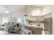 Open kitchen with breakfast bar, stainless steel appliances, and adjacent living room at 4142 Central Sarasota Pkwy # 1428, Sarasota, FL 34238