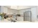Kitchen with stainless steel appliances, white cabinets, and a double sink at 4142 Central Sarasota Pkwy # 1428, Sarasota, FL 34238