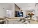Kitchen with double sink, view of living room and access to dining area at 4142 Central Sarasota Pkwy # 1428, Sarasota, FL 34238