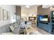 Living room featuring light-colored sofas, a large TV, and a view into the kitchen at 4142 Central Sarasota Pkwy # 1428, Sarasota, FL 34238