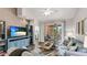Living room with comfortable sofas, large TV, and access to screened balcony at 4142 Central Sarasota Pkwy # 1428, Sarasota, FL 34238