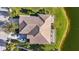 Aerial view of home showcasing tile roof, landscaping, and lakefront location at 4363 Kariba Lake Ter, Sarasota, FL 34243