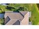 Aerial view of home showcasing tile roof, landscaping, and lakefront location at 4363 Kariba Lake Ter, Sarasota, FL 34243