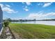 Serene backyard with lush grass leading to lake view at 4363 Kariba Lake Ter, Sarasota, FL 34243