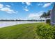 Peaceful backyard oasis with lush grass and lake view at 4363 Kariba Lake Ter, Sarasota, FL 34243