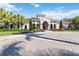 LakeRidge Falls clubhouse exterior with palm trees and landscaping at 4363 Kariba Lake Ter, Sarasota, FL 34243