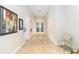 Clean and bright hallway with tiled floors and artwork at 4363 Kariba Lake Ter, Sarasota, FL 34243