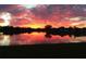 Stunning sunset over lake with home reflection at 4363 Kariba Lake Ter, Sarasota, FL 34243