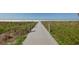Wooden boardwalk through the dunes to the beach at 4937 Oxford Dr, Siesta Key, FL 34242