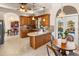 Kitchen island with seating and view into dining area at 4937 Oxford Dr, Siesta Key, FL 34242