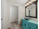 Charming bathroom with teal vanity, decorative sink, and arched mirror at 5164 Windward Ave, Sarasota, FL 34242