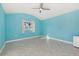Bright bedroom featuring light blue walls and herringbone tile floors at 5164 Windward Ave, Sarasota, FL 34242