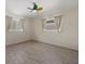 Bright bedroom with wood-look floors and two windows at 5164 Windward Ave, Sarasota, FL 34242