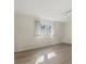 Bright bedroom with light walls, wood-look flooring, and large windows at 5164 Windward Ave, Sarasota, FL 34242