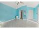 Light blue bedroom with wood-look tile floors and spacious layout at 5164 Windward Ave, Sarasota, FL 34242