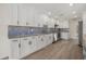 White kitchen with stainless steel appliances and granite counters at 5164 Windward Ave, Sarasota, FL 34242