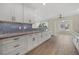 Modern kitchen featuring white cabinets and blue tile backsplash at 5164 Windward Ave, Sarasota, FL 34242