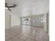 Open living room with tile floors and access to the patio and other rooms at 5164 Windward Ave, Sarasota, FL 34242