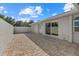 A brick paved patio adjacent to the house, with sliding glass doors leading inside at 5164 Windward Ave, Sarasota, FL 34242