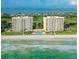 Aerial view of two beachfront highrises with pool and ocean views at 603 Longboat Club Rd # 903N, Longboat Key, FL 34228