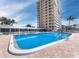 Sparkling community pool with ocean view and building at 603 Longboat Club Rd # 903N, Longboat Key, FL 34228