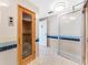 Relaxing sauna with glass door and tiled walls at 603 Longboat Club Rd # 903N, Longboat Key, FL 34228