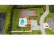 Aerial view of community pool, tennis court, and parking at 6542 Draw Ln # 90, Sarasota, FL 34238