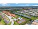 Community overview featuring homes, a pool, and tennis courts at 6542 Draw Ln # 90, Sarasota, FL 34238