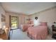 Guest bedroom with two twin beds, wood dresser, and access to a patio at 6542 Draw Ln # 90, Sarasota, FL 34238