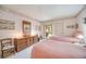 Guest bedroom with two twin beds, wood dresser, and access to a patio at 6542 Draw Ln # 90, Sarasota, FL 34238