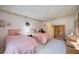 Guest bedroom with two twin beds, wood dresser, and access to a patio at 6542 Draw Ln # 90, Sarasota, FL 34238