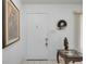 Inviting entryway with a framed painting, wreath, and small table at 6542 Draw Ln # 90, Sarasota, FL 34238