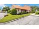 Exterior view of a condo with a tiled roof and landscaping at 6542 Draw Ln # 90, Sarasota, FL 34238