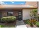 Front view of a condo with a tiled roof, landscaping, and walkway at 6542 Draw Ln # 90, Sarasota, FL 34238