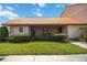 Front view of a condo with a tiled roof, landscaping, and walkway at 6542 Draw Ln # 90, Sarasota, FL 34238
