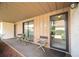 Condo front porch with seating and sliding glass doors at 6542 Draw Ln # 90, Sarasota, FL 34238