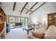 Living room with vaulted ceiling, exposed beams, and sliding glass doors at 6542 Draw Ln # 90, Sarasota, FL 34238