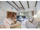 Living room with vaulted ceiling, exposed beams, and sliding glass doors at 6542 Draw Ln # 90, Sarasota, FL 34238