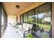 Spacious screened patio featuring comfortable seating and sliding glass doors at 6542 Draw Ln # 90, Sarasota, FL 34238